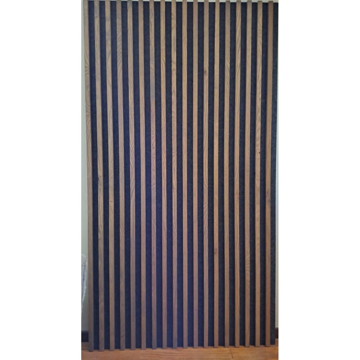 Acoustic slat wall panel made with white oak and charcoal acoustic board