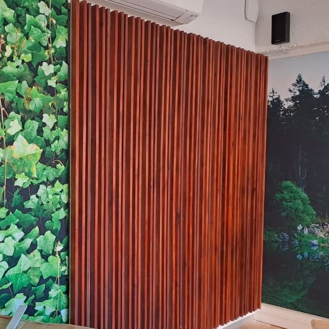Pine slat wall panels with mahogany stain, installed in Yoga studio